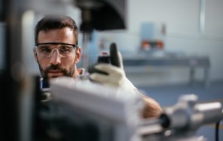 Manufacturing Worker Checking Piece