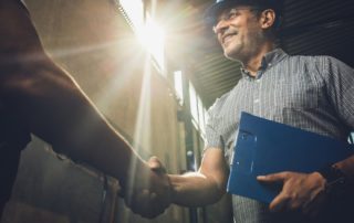 Construction Worker Shaking Hands with Another Employee